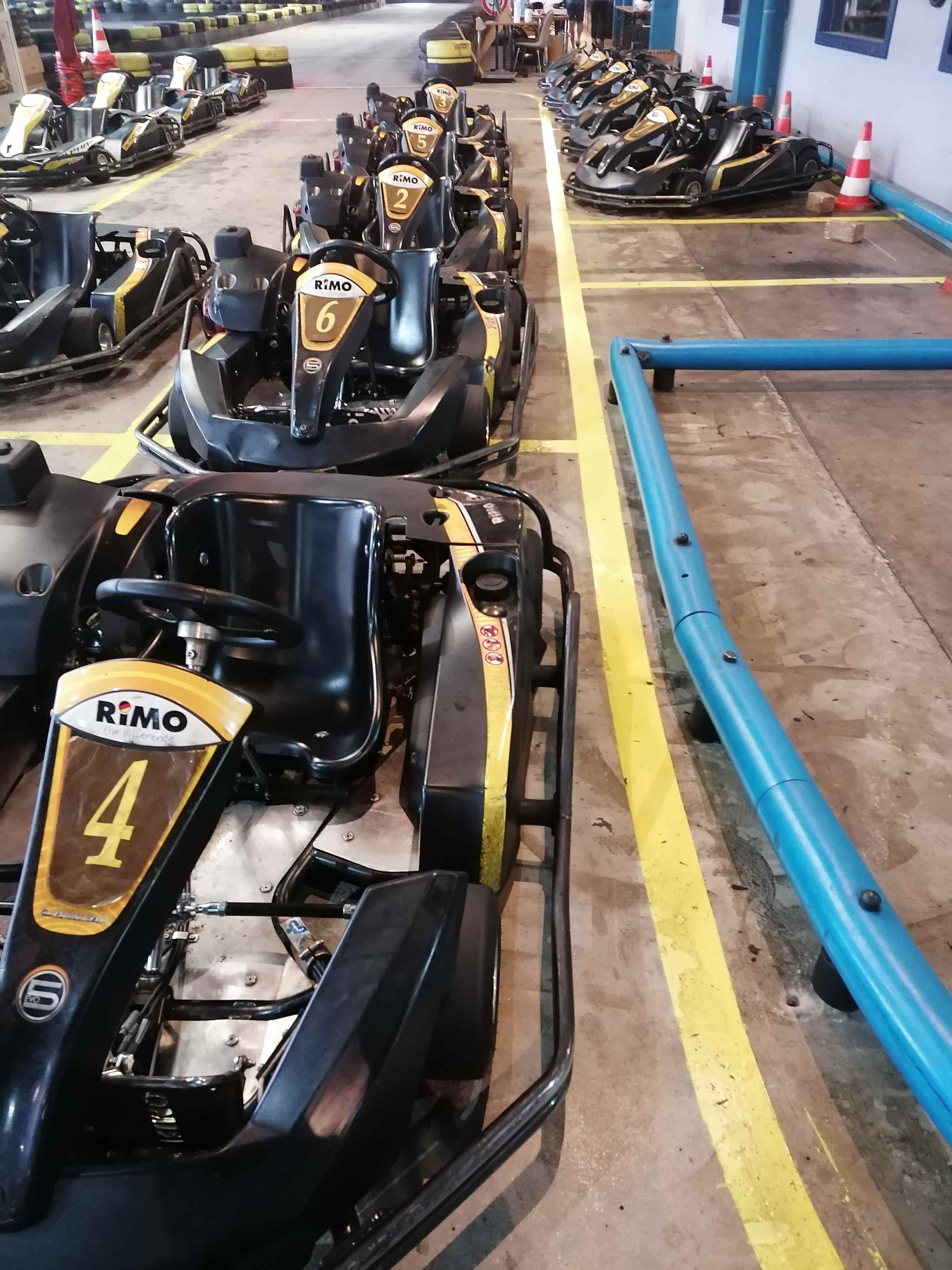A fleet of RiMO karts lined up in the pit lane